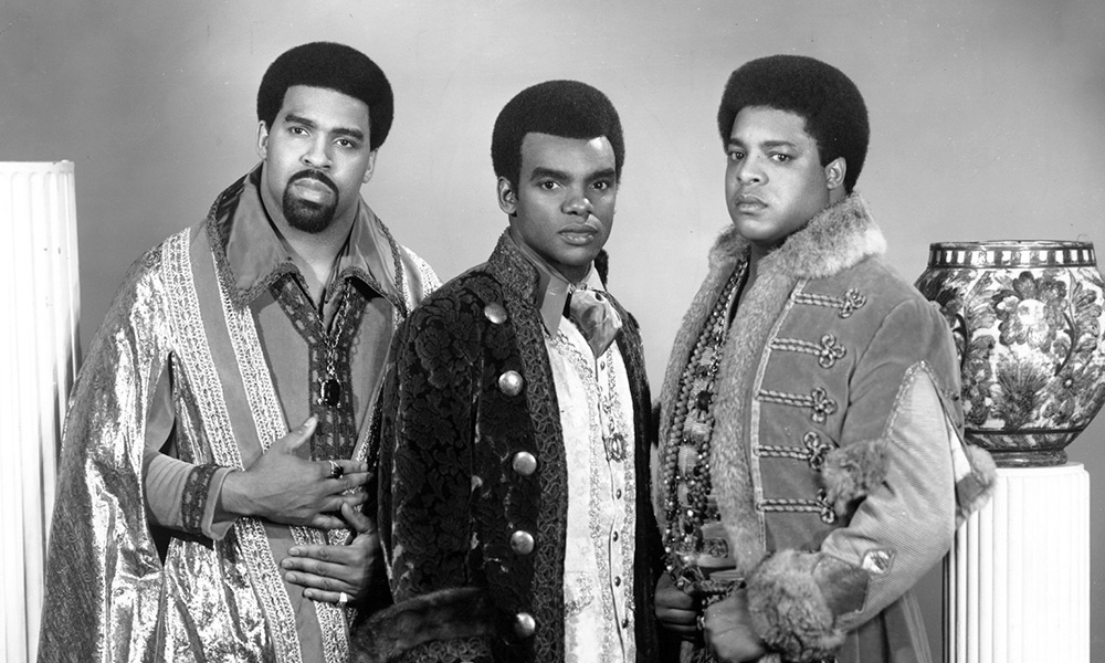 Vocal trio, The Isley Brothers, posing for a black and white portrait
