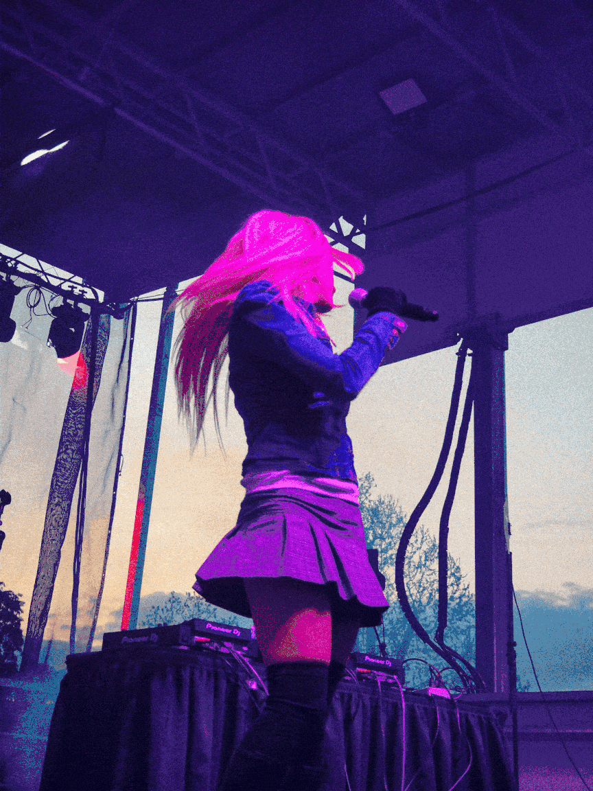 Cowgirl Clue on stage in pink lighting GIF