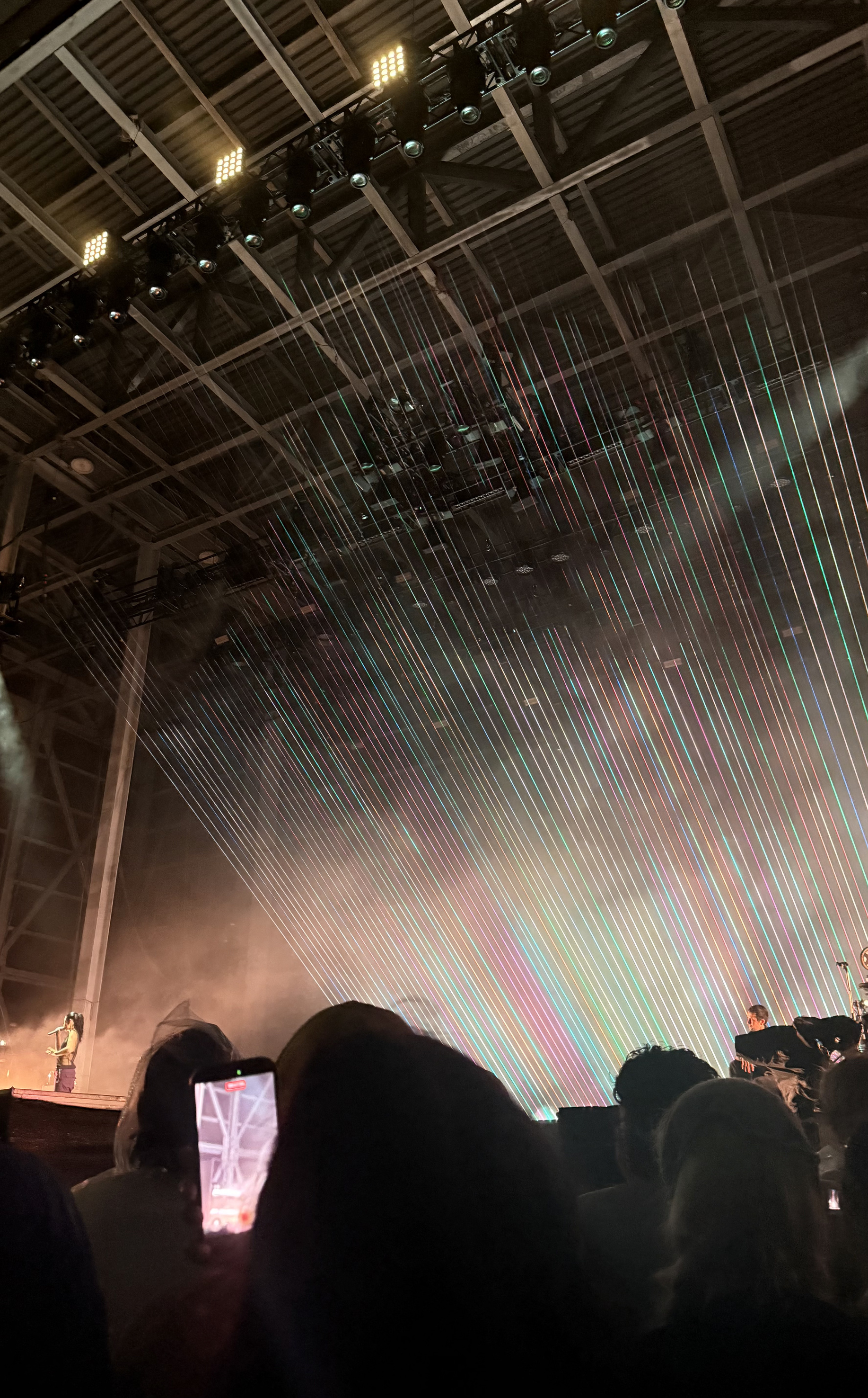 Colorful light beams shooting into the sky, taken from the VIP pit