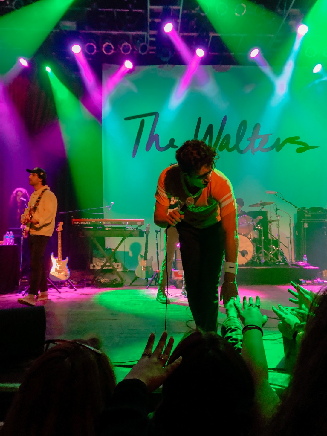 The Walters performing in front of colorful stage lights