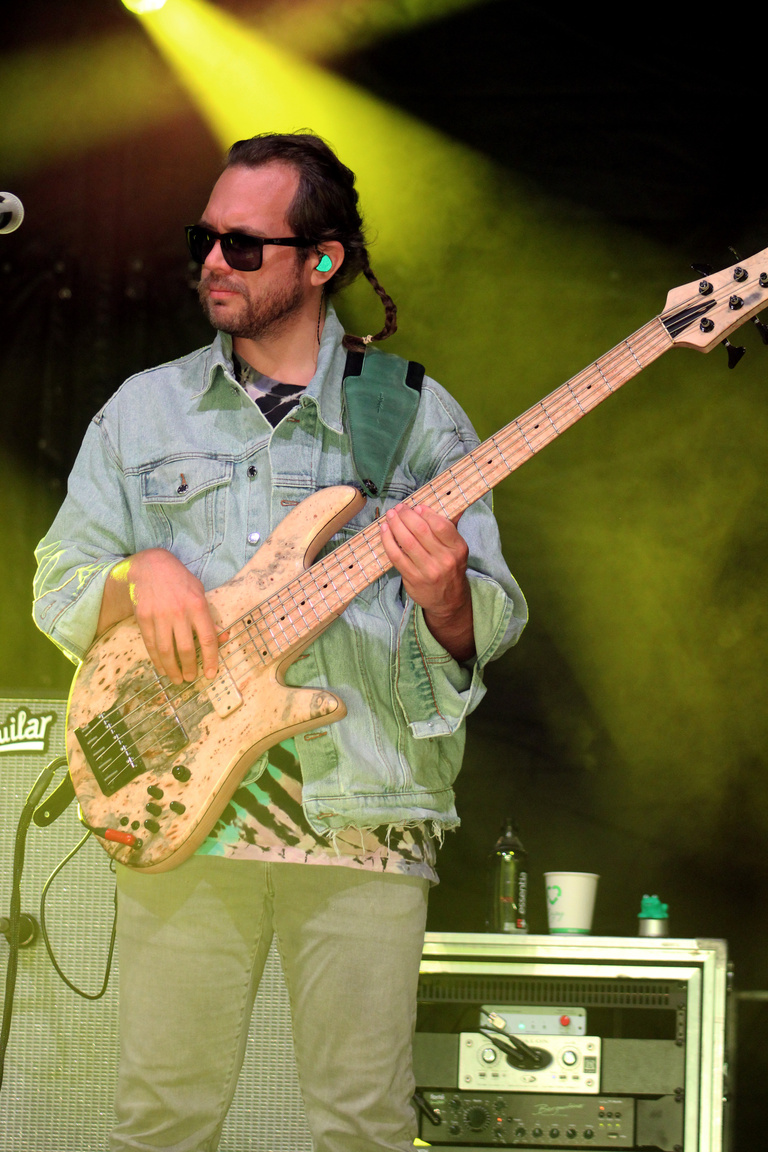 Bass player of Goose on stage with green lighting