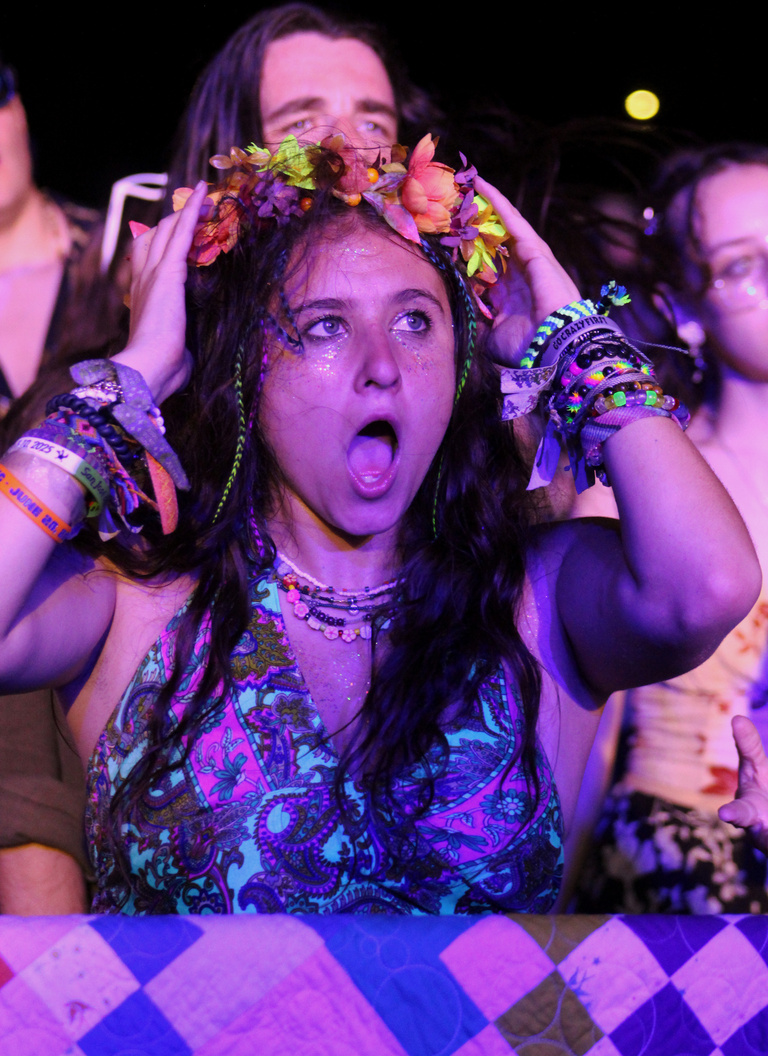 fan in flower crown in awe of performance