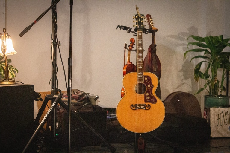 Guitars on their racks with lamp on the left side