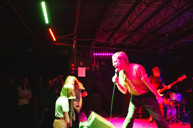 Lip critic on stage. Horizontal show including crowd