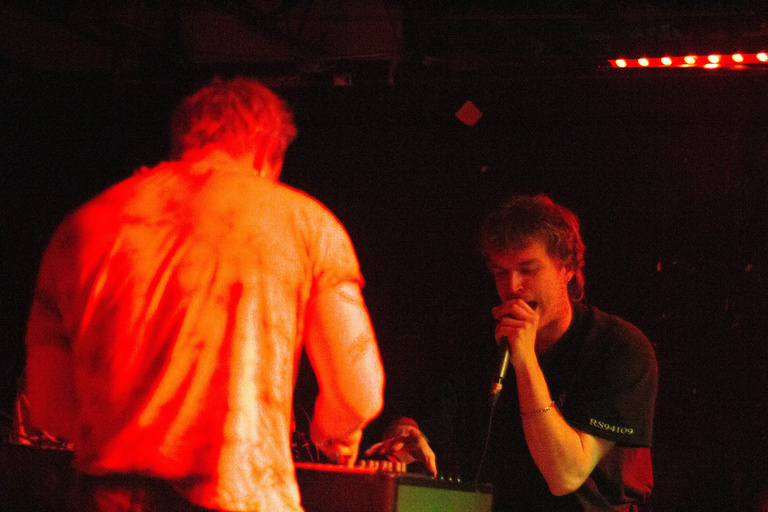 Lip critic on stage with orange lighting
