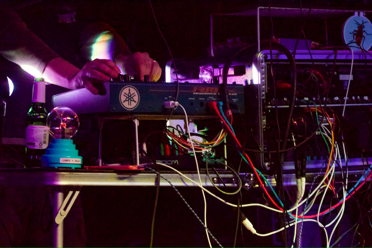 Close up shot of DJ (Birdlabs) performing on stage on sound table