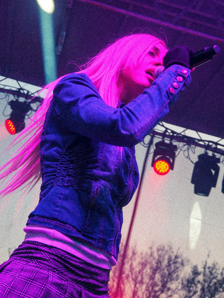 Cowgirl Clue on stage in pink lighting