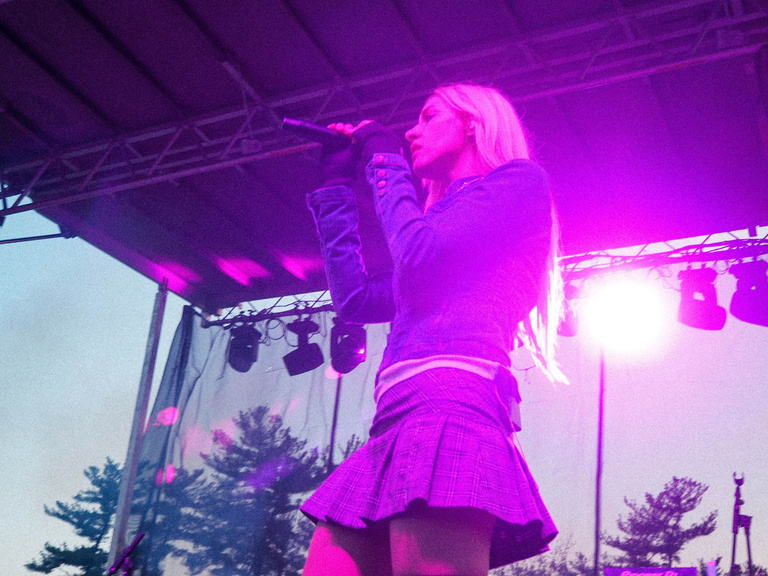 Cowgirl Clue on stage in pink lighting