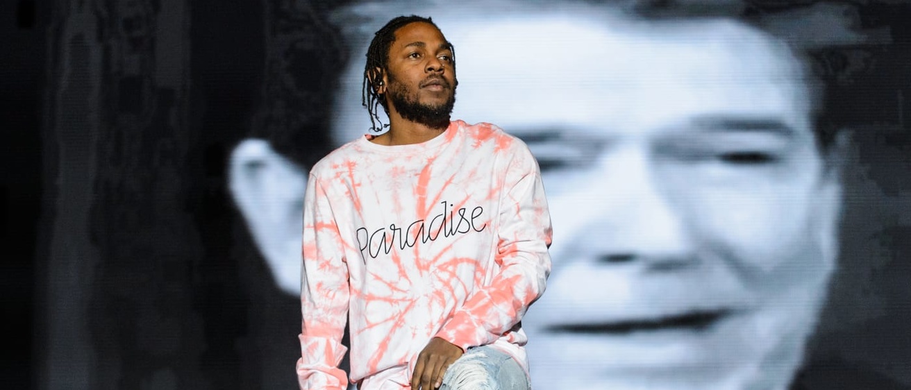 Kendrick Lamar performing with a backdrop of Ronald Reagan 