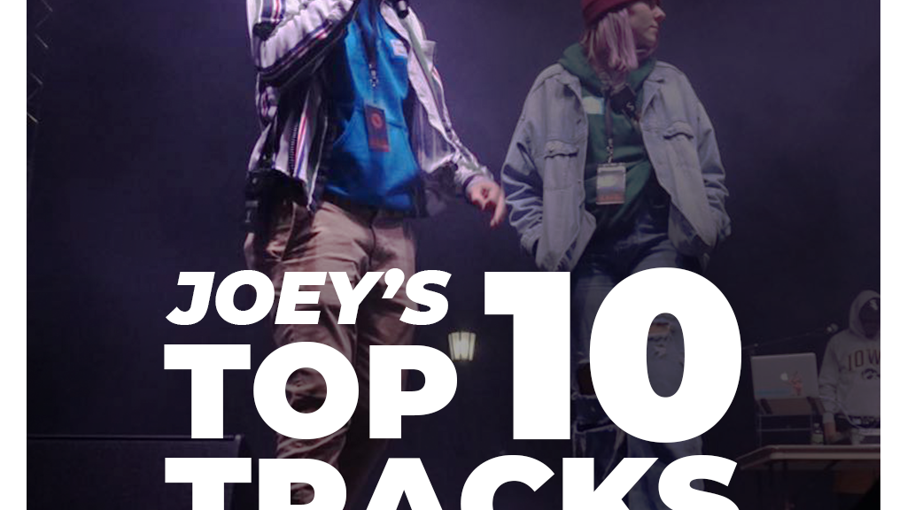 Contains the text "Joey's top 10 tracks of 2021" with a person performing with a microphone